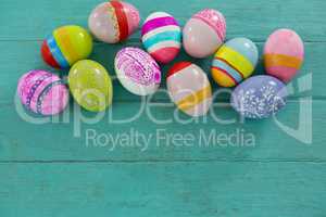 Painted Easter eggs on wooden plank