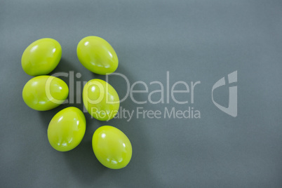 Green Easter eggs on grey background
