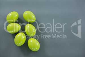 Green Easter eggs on grey background