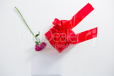 Gift box and pink flower with blank paper