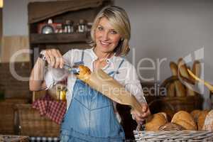 Female staff packing sweet food in paper bag