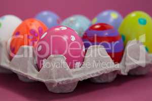 Colorful Easter eggs in egg carton