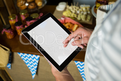 Staff using digital tablet in grocery shop