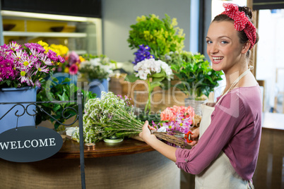 Female florist preparing flower bouquet in flower shop