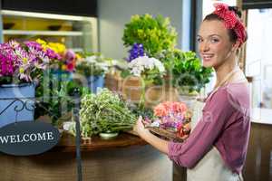 Female florist preparing flower bouquet in flower shop