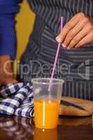 Male staff putting straw in a glass