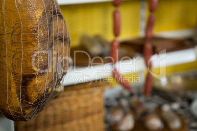 Meat hanging in net at meat counter in market