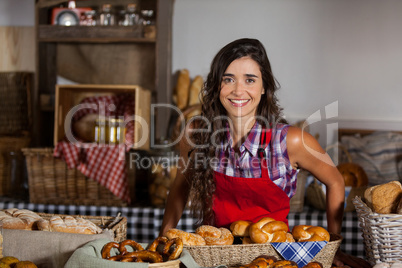 Portrait of female staff standing at bakery section