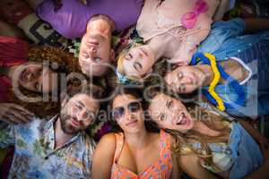 Group of friends lying in a circle at campsite