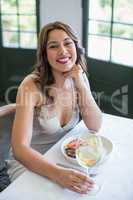 Woman smiling while holding wine glass in the restaurant