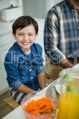 Portrait of smiling boy sitting at dining table