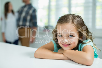 Portrait of smiling girl sitting in living room