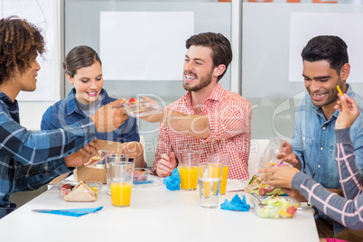 Happy executives interacting while having breakfast