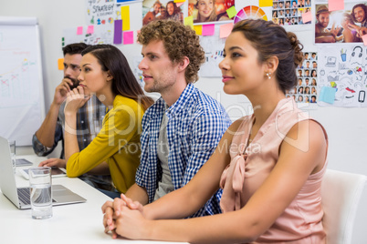 Executives listening presentation in conference room