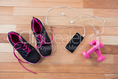 Mobile phone with headphones, shoes and dumbbells