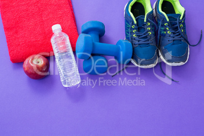Water bottle, towel, apple, dumbbells and sneakers