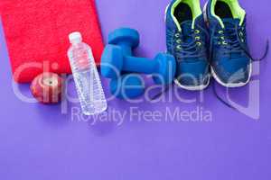 Water bottle, towel, apple, dumbbells and sneakers