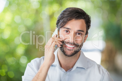 Man smiling while talking on his mobile phone
