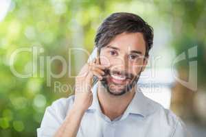 Man smiling while talking on his mobile phone