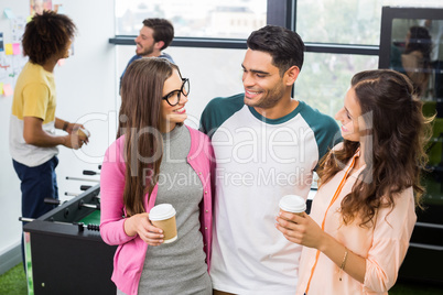 Happy executives interacting while having coffee