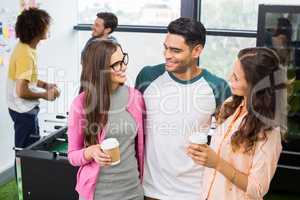 Happy executives interacting while having coffee