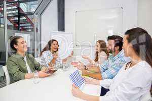 Smiling executive interacting during meeting in conference room