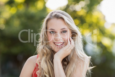 Beautiful woman with hand on her chin smiling