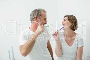 Couple brushing their teeth with toothbrush at home