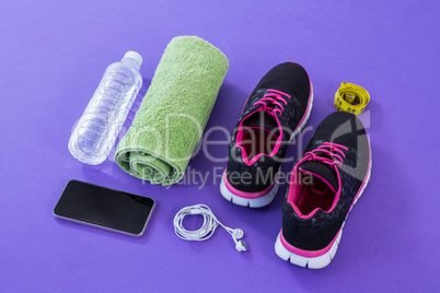 Sneakers, water bottle, towel, measuring tape, mobile phone and headphones