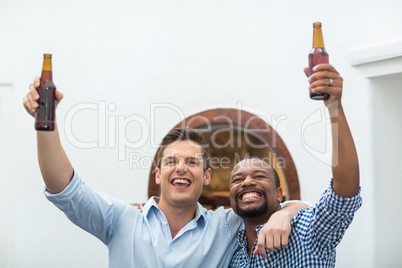 Friends cheering while watching football match