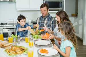 Smiling family having lunch together on dining table