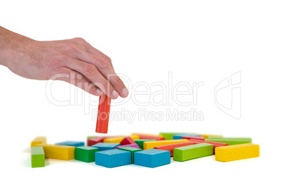 Hand arranging building blocks