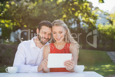 Couple using digital tablet in a restaurant