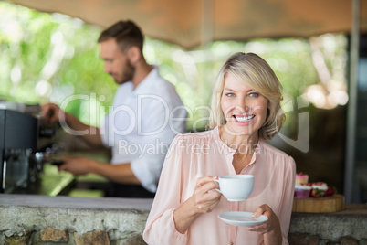Woman holding coffee cup in a restaurant