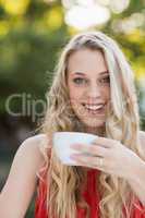 Beautiful woman smiling while having coffee