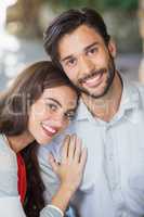 Woman resting her head on mans shoulder in the restaurant