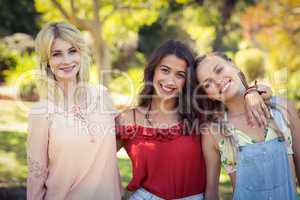 Friends standing together in park