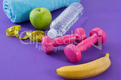 Dumbbell, apple, towel, water bottle and measuring tape
