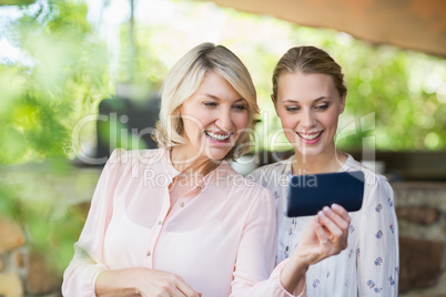 Friends using mobile phone at restaurant