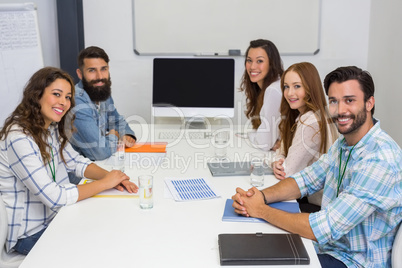 Portrait of smiling executive in conference room during meeting