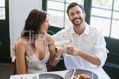 Happy couple toasting wine glasses