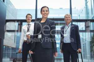 Business executives with trolley bag standing