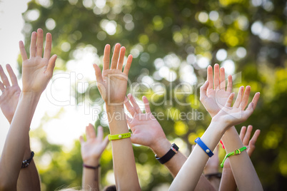 Friends raising their hands while dancing at music festival