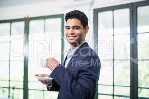 Portrait of businessman holding coffee cup