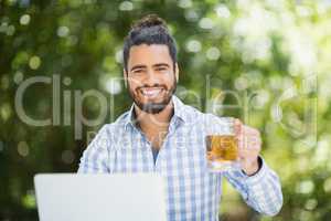 Happy holding beer glass in a restaurant