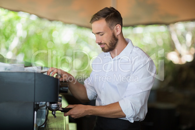 Waiter preparing espresso at restaurant