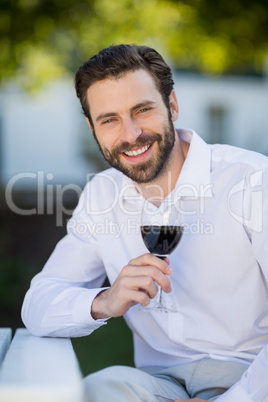 Man holding glass of wine in the park