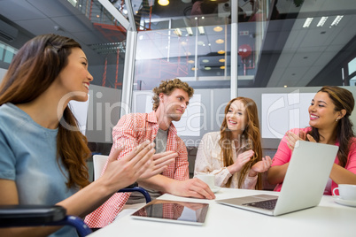 Executives appreciating their colleague during meeting in conference room