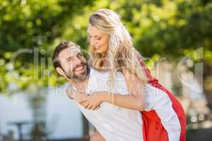 Man giving piggyback ride to woman