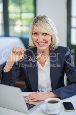 Businesswoman using laptop in a restaurant